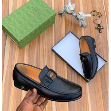 Black Loafer with a Metal Emblem.