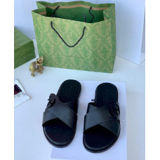 black slide sandals with a loop design on the strap