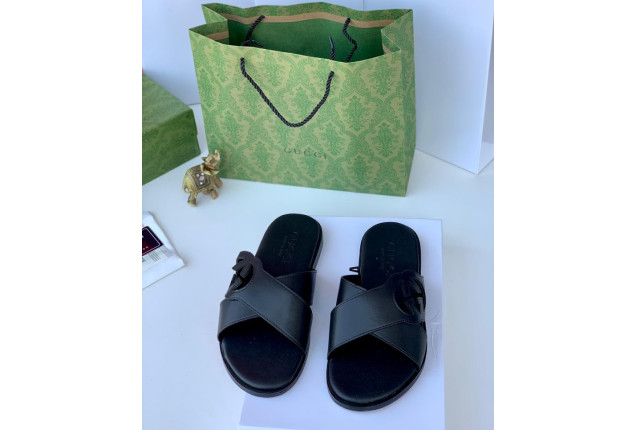 black slide sandals with a loop design on the strap