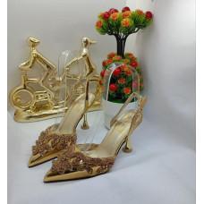 Gold high-heeled shoes