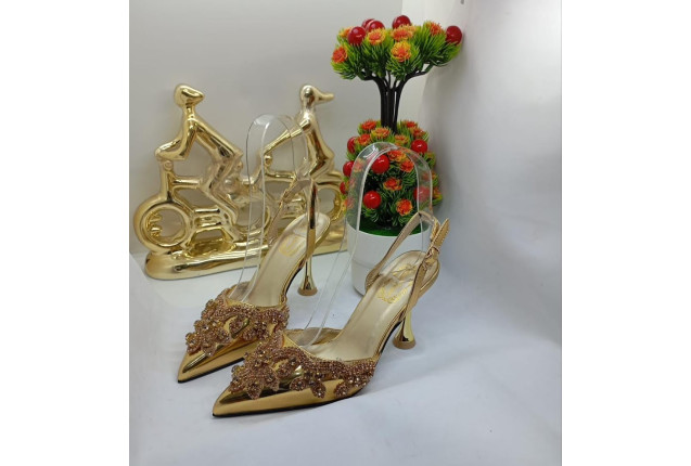 Gold high-heeled shoes